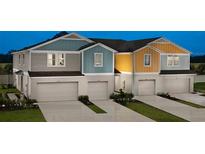 Charming townhomes feature colorful exteriors, private garages, and manicured landscaping, perfect for modern living at 3766 King Hill Dr, Haines City, FL 33844