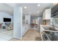 Bright kitchen with stainless steel appliances, white cabinets, and modern countertops at 820 Lamp Post Ln, Lakeland, FL 33809