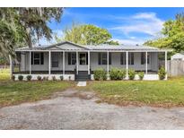 Charming single-story home with screened-in porch and well-maintained landscaping at 4844 Creek Meadow Trl, Lakeland, FL 33810