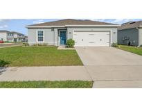 Charming single-story home with a well-manicured lawn and a two-car garage at 1336 Madison Cir, Haines City, FL 33844