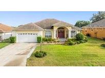 Inviting one-story home with a well-manicured lawn and attached two-car garage at 2522 Pine Valley Dr, Lakeland, FL 33810