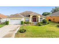 Charming single Gathering home displaying a beautiful lawn and front garden at 2522 Pine Valley Dr, Lakeland, FL 33810