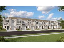 Row of townhouses with neutral colors, garages, and well-maintained landscaping on a sunny day at 3090 Chantilly Dr, Davenport, FL 33837