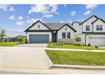 Charming single-story home with a well-manicured lawn and a gray garage door at 16998 Cedar Valley Cir, Clermont, FL 34711