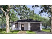 Charming single-story home featuring a brick walkway, attached garage, and inviting front door at 332 W 8Th St, Lakeland, FL 33805