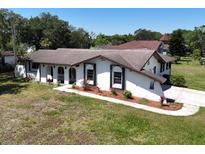 Stunning single-story home featuring a unique architectural design and a well-manicured front yard at 1968 Pleasant Hill Rd, Kissimmee, FL 34746