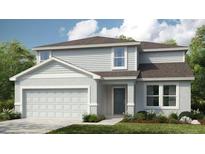 Charming two-story home featuring manicured lawn and a two-car garage at 2084 Babbling Brook Blvd, Auburndale, FL 33823