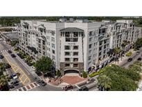 Modern apartment building featuring a brick entrance, balconies, and stylish architectural details at 2305 Edgewater Dr # 1606, Orlando, FL 32804