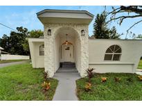 Inviting front entrance with stone archway, modern lighting, and well-maintained landscaping enhances curb appeal at 800 N Church Ave, Mulberry, FL 33860