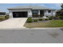 Charming single-story home with a well-manicured front yard and an open garage at 8890 Sw 104Th Cir, Ocala, FL 34481