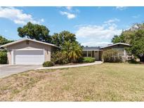 Charming single-story home with a well-maintained front yard and attached garage at 4012 Shorecrest Dr, Orlando, FL 32804