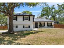 Charming two-story home with a well-manicured lawn and beautiful curb appeal under a sunny sky at 1352 Charlotte St, Altamonte Springs, FL 32701