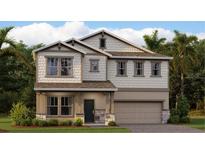 Charming two-story home featuring a covered porch and a two-car garage with manicured lawn at 3207 Armstrong Ave, Clermont, FL 34714