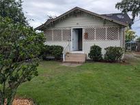 Quaint single story home featuring a well-maintained lawn and charming latticework on the front porch at 1529 Indiana St, Orlando, FL 32805