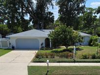 Well-maintained home featuring a charming front yard and a freshly painted white exterior with an attached garage at 3446 Country Manor Dr, Port Orange, FL 32129