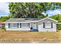 Charming one-story home featuring a neutral exterior, well-maintained lawn and traditional architectural details at 1480 E Davidson St, Bartow, FL 33830