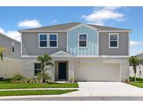 Charming two-story home featuring a two-car garage, landscaped yard and inviting curb appeal at 1620 Ellesmere Ave, Haines City, FL 33844