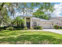 Charming one-story home featuring a manicured lawn and beautiful landscaping at 917 Keep Way Loop, Oviedo, FL 32765