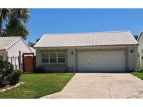Charming single-story home with a well-maintained lawn and a white tile roof, offering classic curb appeal at 242 Rosa Blanca, Winter Haven, FL 33884