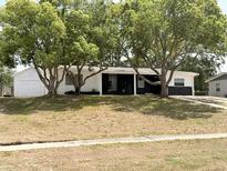 Charming single-story home with mature trees, freshly painted in white and black trim at 1505 Piedmont Dr, Deltona, FL 32725