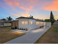 Charming single-story home featuring a well-manicured lawn, and a private carport at 3043 Sego Ln, Lakeland, FL 33801