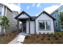Charming single-Gathering home with inviting front porch and beautifully landscaped front yard at 3102 Voyager Ave, St Cloud, FL 34771