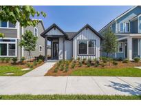 Charming single-story home with a modern facade, complemented by a well-maintained front yard and walkway at 3102 Voyager Ave, St Cloud, FL 34771