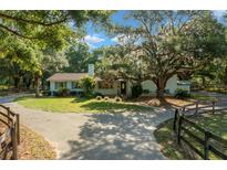 Charming single-story home with a well-manicured lawn and mature trees providing ample shade at 7795 Sw 72Nd Ct, Ocala, FL 34476