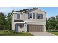 Charming two-story home with grey siding, a 2-car garage, and well-manicured lawn at 3506 Kimbrough Dr, Lake Wales, FL 33859