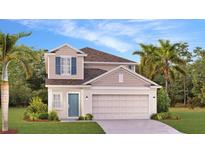 Charming two-story home featuring a two-car garage, inviting entryway, and landscaped front yard at 5657 Portico Pl, Kissimmee, FL 34758