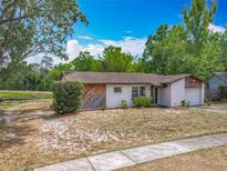 Charming single-story home featuring a well-maintained lawn and attached garage at 9526 Turkey Oak Bnd, Orlando, FL 32817