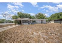 View of home, featuring covered carport and screen porch in need of renovation at 129 5Th Jpv St, Winter Haven, FL 33880
