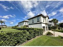 Beautiful two-story home featuring well-maintained landscaping and a private two-car garage at 1056 Castle Pines Ct, Reunion, FL 34747
