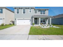 Charming two-story home featuring a well-manicured lawn and a two-car garage at 5616 Siltstone St, Lakeland, FL 33811