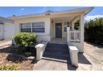 Charming home featuring a covered porch, and a quaint, landscaped front yard at 206 W 9Th St, Lakeland, FL 33805