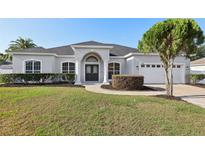 Charming one-story home featuring a manicured front lawn and a classic double-door entrance at 1046 Island Pointe Dr, Winter Garden, FL 34787