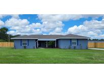Charming single story home boasts a spacious front yard and a quaint covered entryway at 8804 Harrison Rd, Lakeland, FL 33810