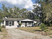 Charming single-story home with a well-maintained front yard and mature trees at 917 Adamson Ct, Lake Alfred, FL 33850