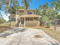 Charming home featuring a covered porch and ample parking space at 713 W 3Rd St, Lakeland, FL 33805