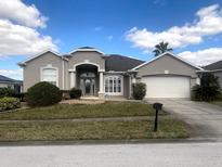 Charming single-story home with manicured lawn and well-maintained landscaping at 242 Prestwick Dr, Davenport, FL 33897