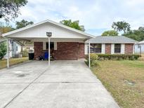 Charming single-story brick home featuring a covered carport and well-maintained landscaping at 1690 S Mcadoo Ave, Bartow, FL 33830