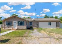 Charming single story home with neutral exterior, driveway, sidewalk, and partially-landscaped front yard at 211 Nw 8Th St, Mulberry, FL 33860