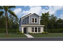 Charming two-story home showcasing a modern blue and grey exterior with lush landscaping and a welcoming entrance at 2105 Stake Out Way, Apopka, FL 32703