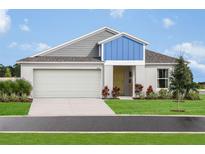 Charming single-Gathering home with a well-manicured lawn and a two-car garage on a sunny day at 1054 Foreshore Ln, Haines City, FL 33844