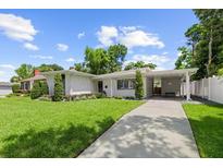 Beautiful single-story home featuring a carport and manicured lawn and front garden at 1105 Chichester St, Orlando, FL 32803