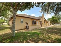 Side view of the townhome featuring well-maintained grounds and lovely landscaping at 56 Pine Trak # 101E, Ocala, FL 34472