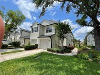 Charming two-story townhome with a well-manicured lawn and a welcoming front entrance at 6059 Twain St # 108, Orlando, FL 32835