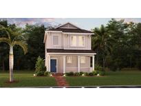 Inviting two-story home features a charming front porch, landscaped yard, and a welcoming blue front door at 2433 Spring Tune Aly, Kissimmee, FL 34744