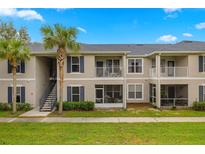 Inviting exterior view of a two-story condo building with balconies and well-maintained landscaping at 4014 Hemingway Cir # 4014, Haines City, FL 33844