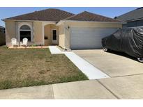 Inviting single-story home featuring a well-manicured lawn and attached two-car garage at 2057 Swift Rd, Oviedo, FL 32766